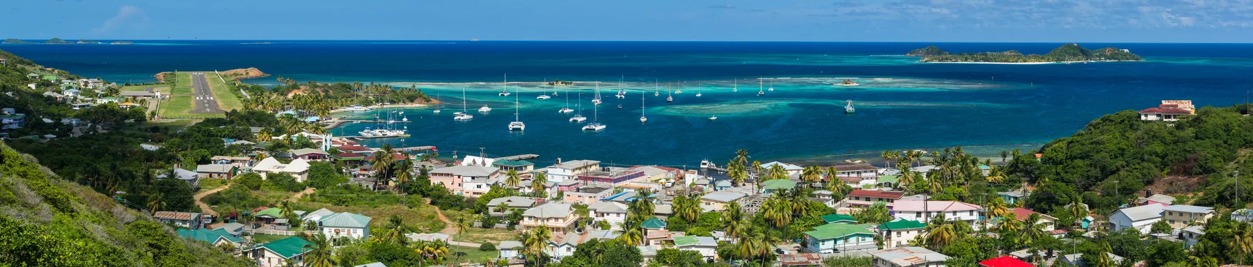 Panoramic view of Clifton town and visiting sailboats anchored in the harbour