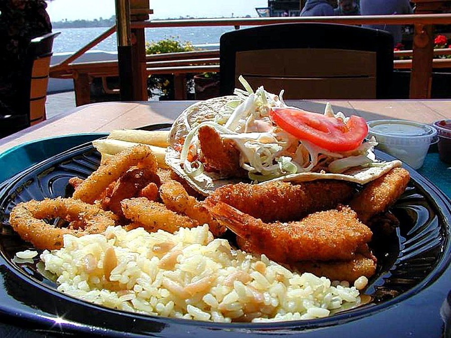 Caribbean fish, rice and local food plate served by the water